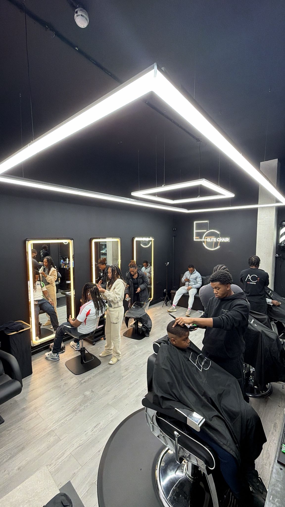 Busy Elite Chair Barber studio with barbers and hairdressers working in Canning Town