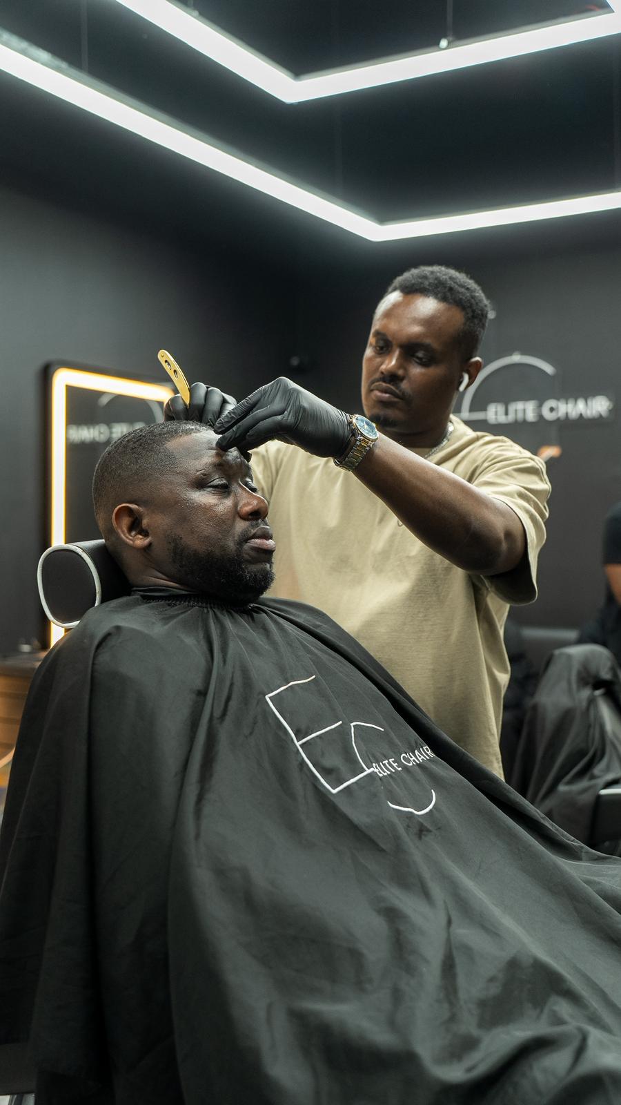 Elite Chair Barber working with razor detail and precision